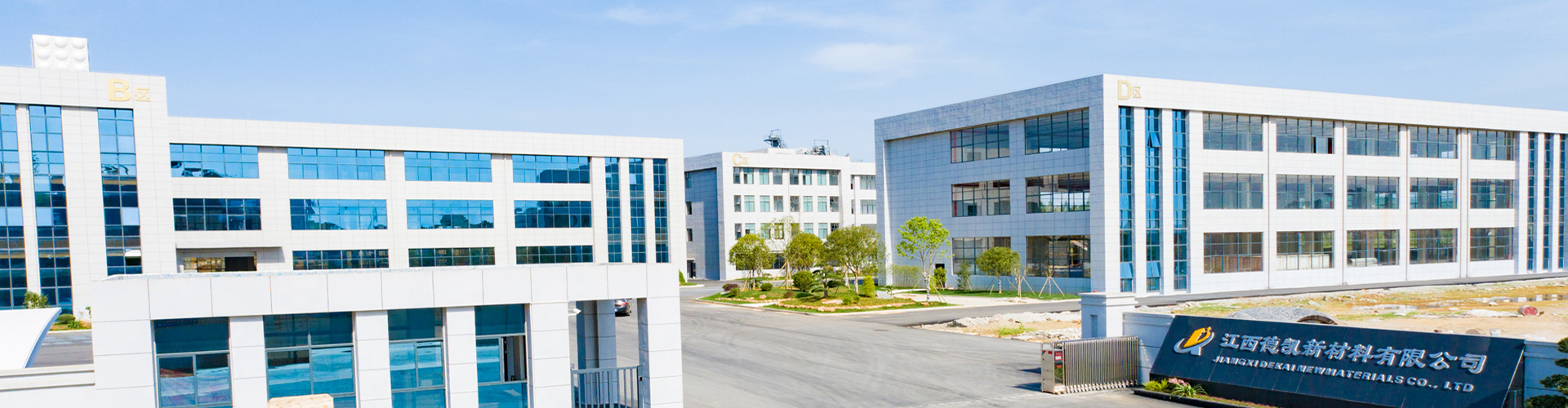 Factory gate with view of company buildings